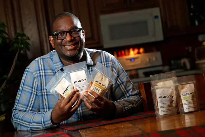 an image of Yaw Asare, he sells the peanut brittle that doesn't stick to your teeth